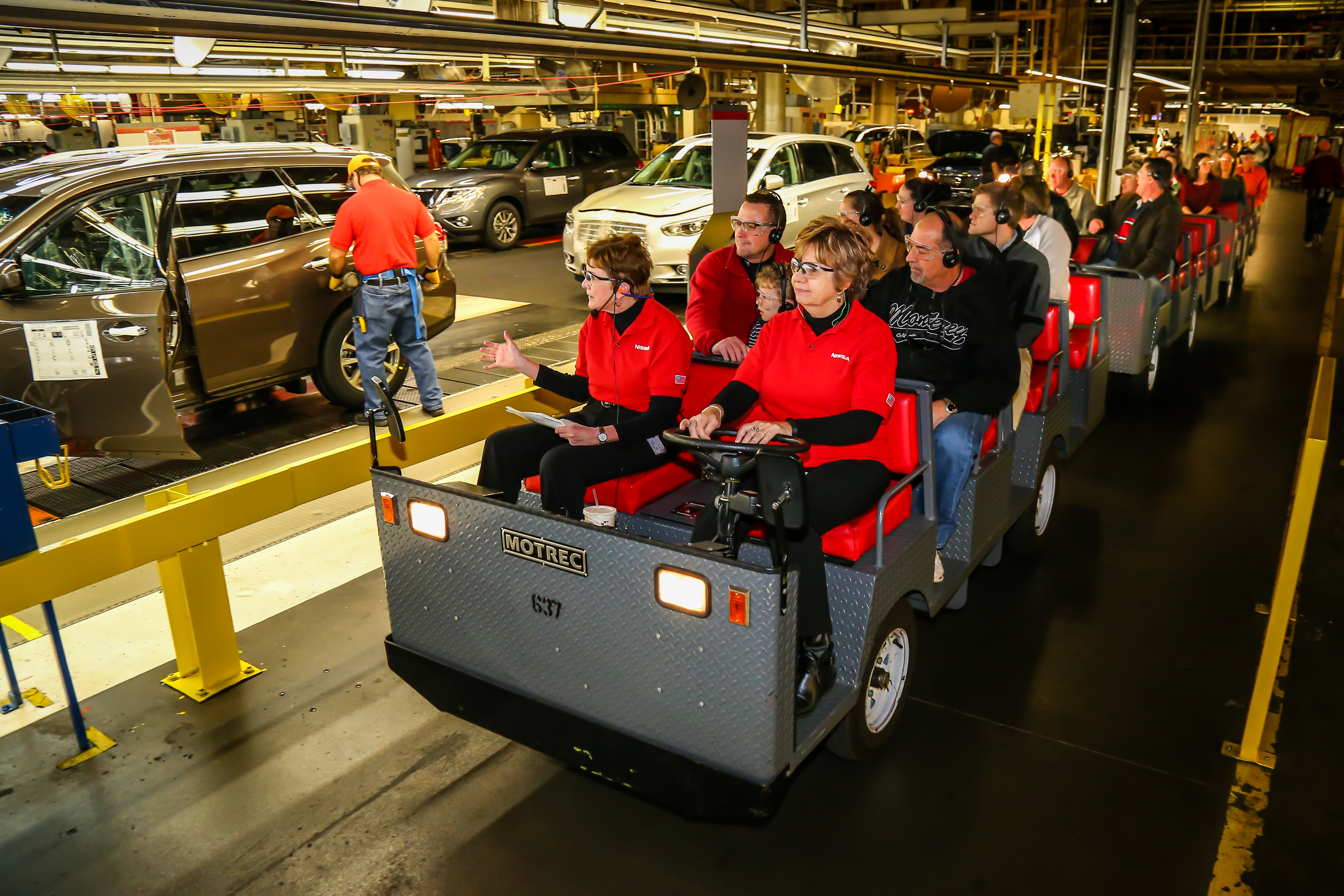 A tour group riding through the Nissan plant in Smyrna.