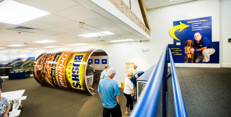 Visitors walking through the Bush's Beans interactive exhibits, like the bean can filled with videos and more information.