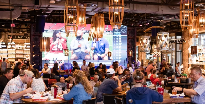 Guests sitting at tables inside 6th + Peabody complex in Nashville