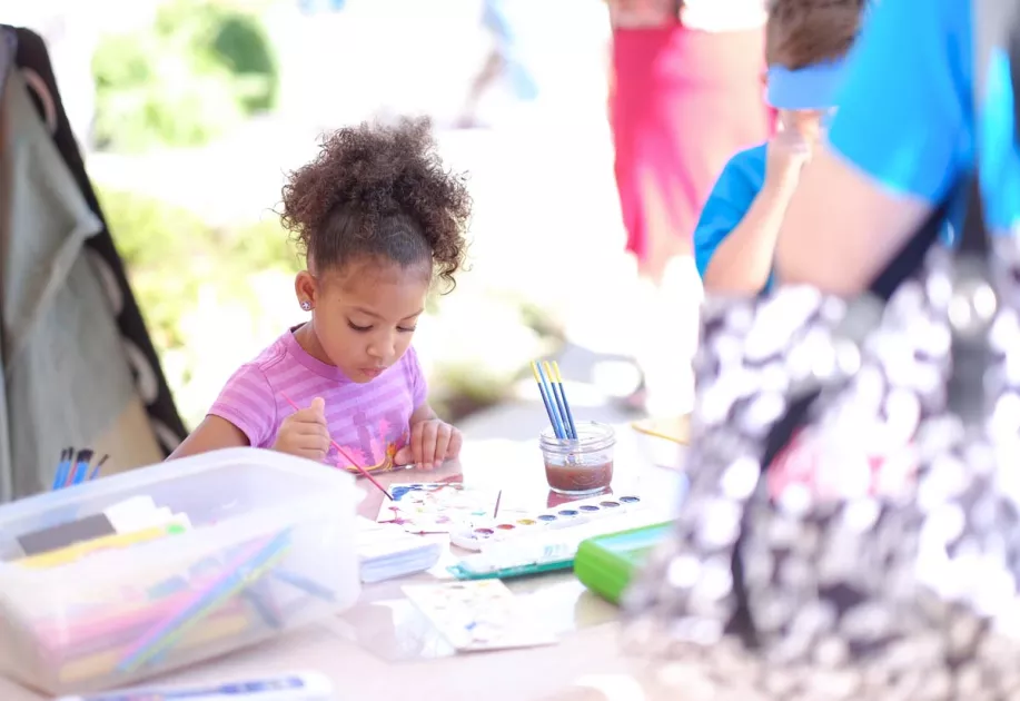 Child making art at the Jackson Square Lavender Festival